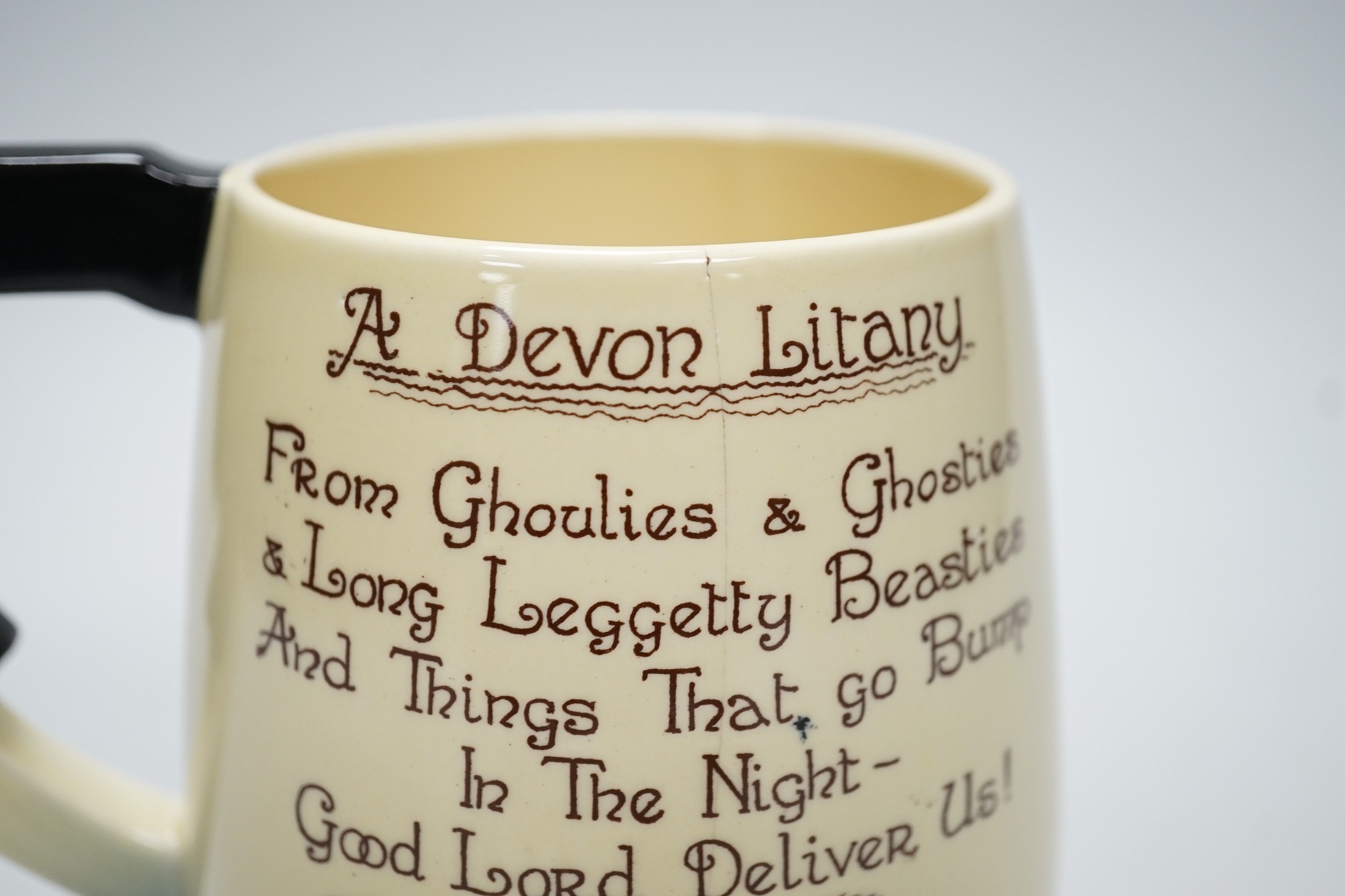 An unusual Carlton Ware, ‘Devon Litany’ tankard, 12cms high